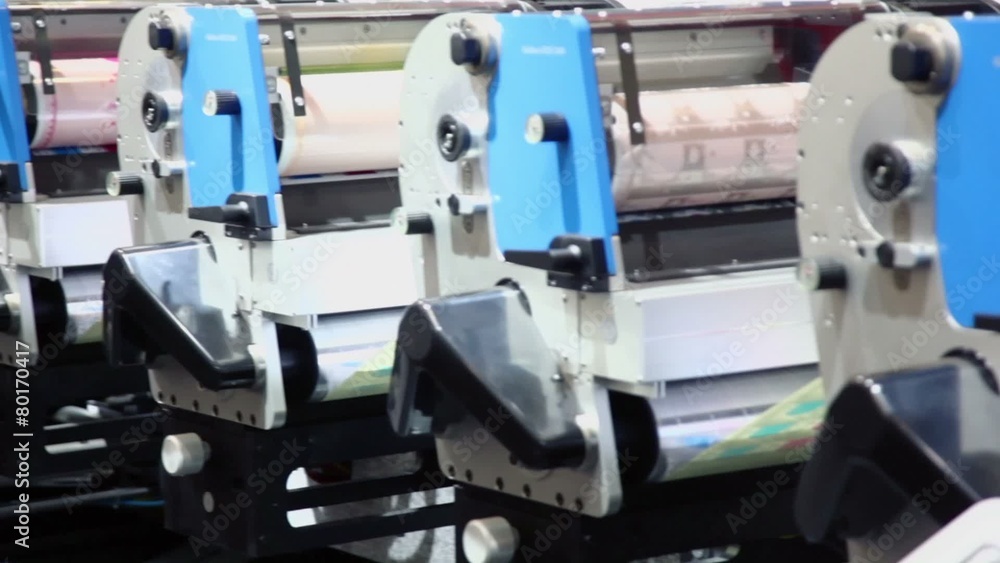 Row of machines in printing conveyor, shown in motion Row of machines in printing conveyor, shown in motion