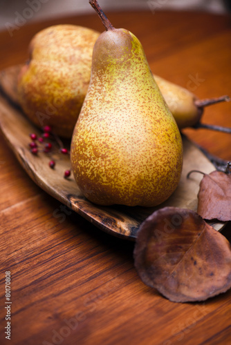 Pears on wooden plate