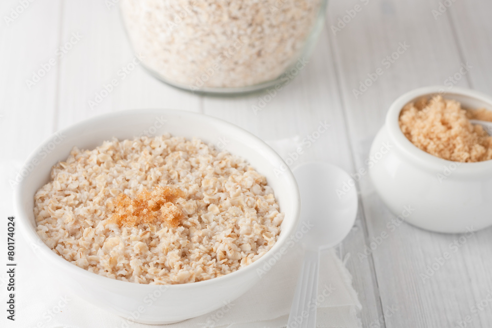 a bowl of cooked oatmeal with brown sugar a bowl of cooked oatmeal with brown sugar