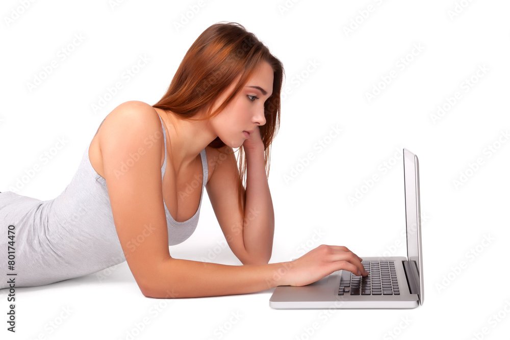 Young Girl Having Online Shopping on Laptop on the Floor Young Girl Having Online Shopping on Laptop on the Floor
