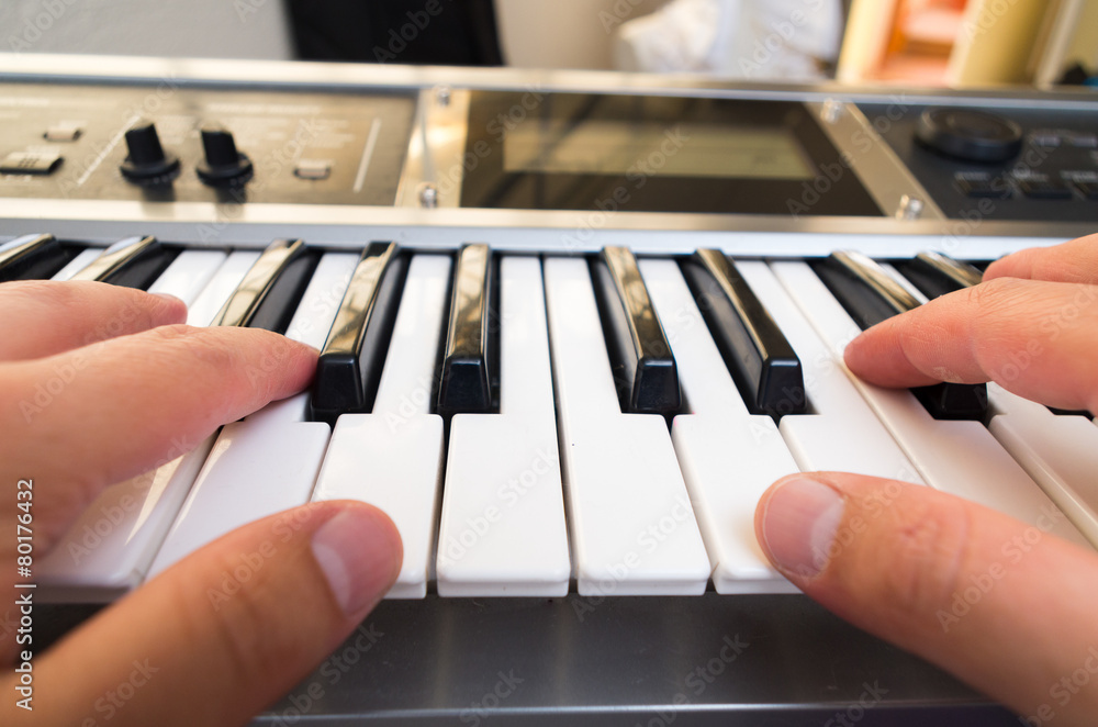 Fototapeta premium closeup photo of a person's hands playing piano
