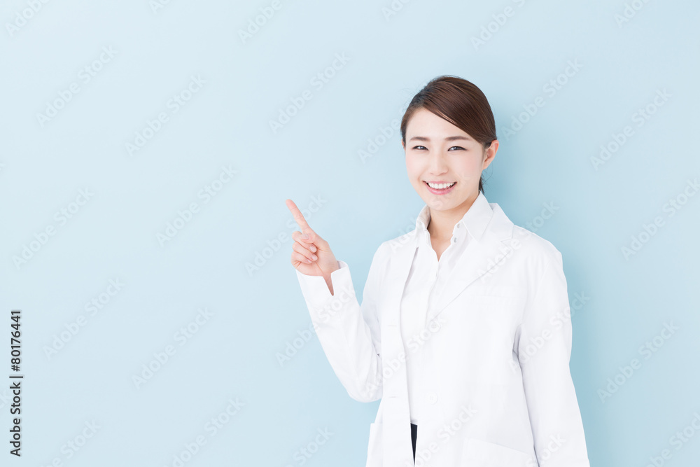 young asian doctor on blue background young asian doctor on blue background