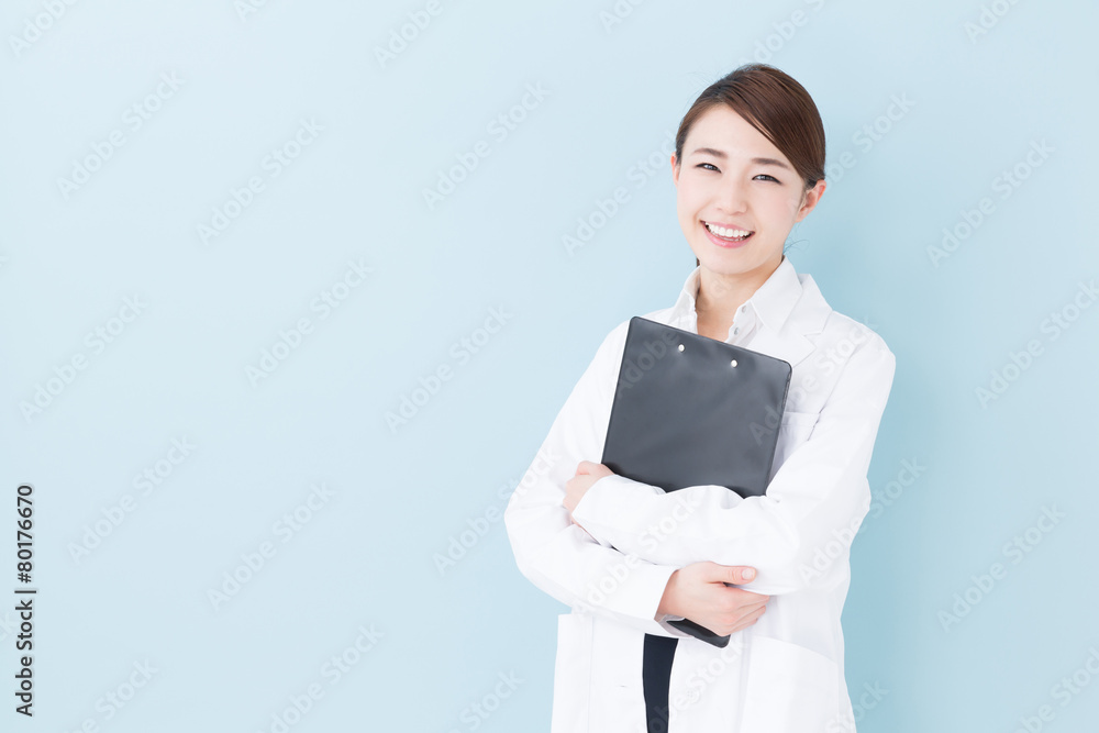 young asian doctor on blue background Stock Photo | Adobe Stock
