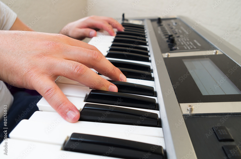 Fototapeta premium closeup photo of a person's hands playing piano