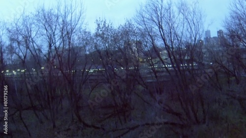 Cityscape with illuminated railroad station and dwelling houses photo