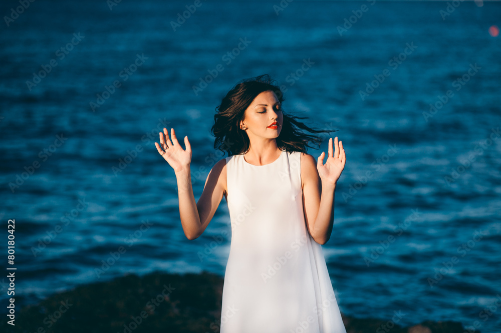 beautiful girl relaxes on the rock on the coast mole beautiful girl relaxes on the rock on the coast mole