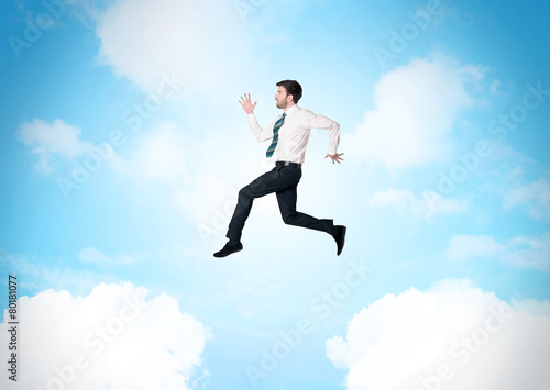 Wallpaper Mural Business person jumping over clouds in the sky Torontodigital.ca