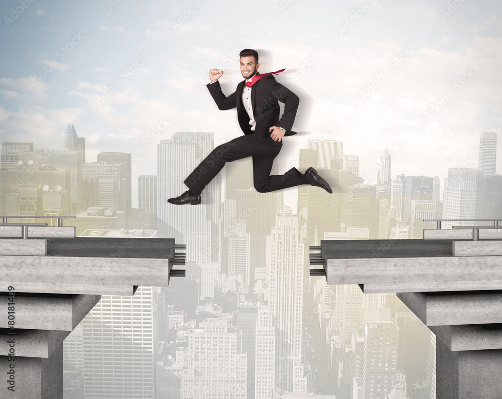Energetic business man jumping over a bridge with gap Energetic business man jumping over a bridge with gap