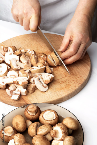 Cutting the chestnut mushrooms into thin slice
