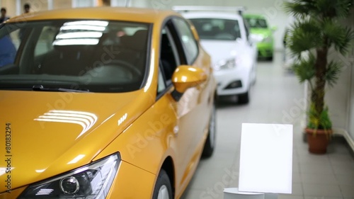 New yellow, white and green shining cars stand in office photo