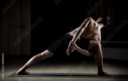  man doing yoga in a sports hall 3