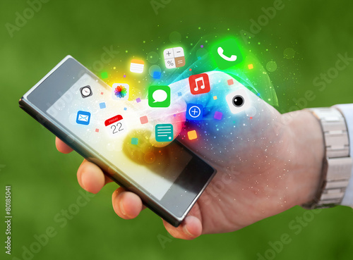 Hand holding smartphone with colorful app icons