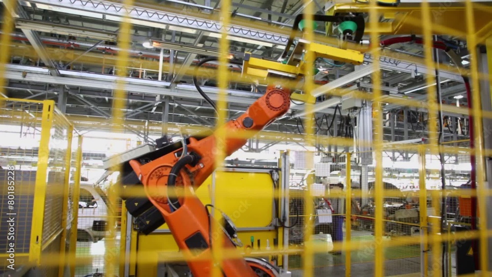 Motion of robotics which weld car components at factory workshop Motion of robotics which weld car components at factory workshop