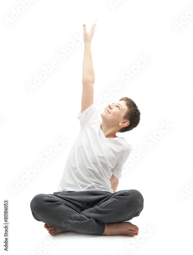 Young boy stretching or doing yoga © exopixel