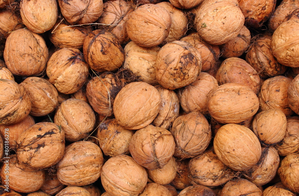 Brown and fresh walnuts as background Brown and fresh walnuts as background