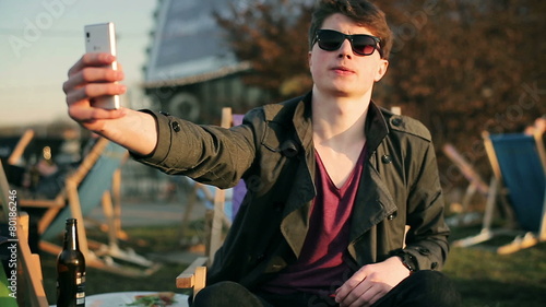 Student doing selfie in outdoor restaurant