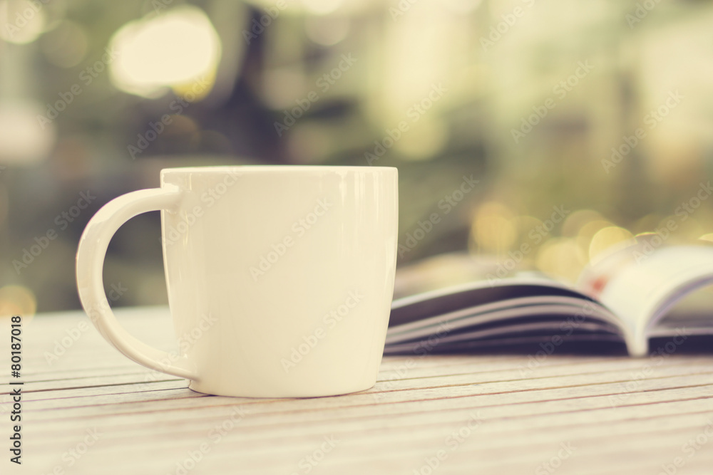 Coffee cup & book on wood table Coffee cup & book on wood table