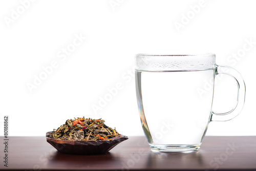 Aromatic antioxidant green tea on wooden board, isolated backgro