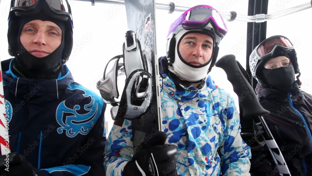 Two men and teenager go in cabin of cable car to ski Two men and teenager go in cabin of cable car to ski