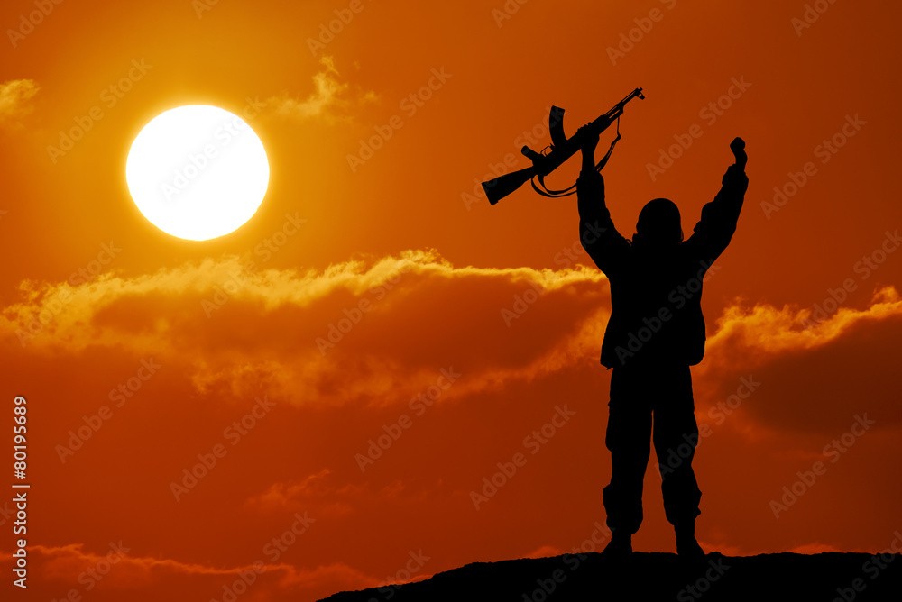 Silhouette of military soldier officer with weapons at sunset