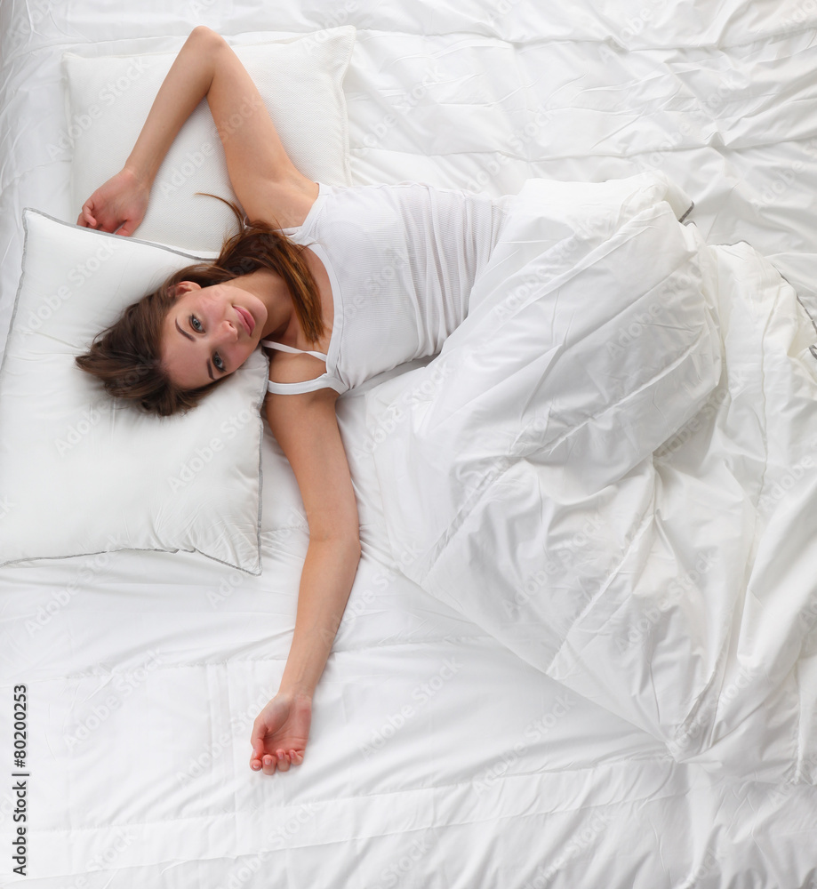 Beautiful girl sleeps in the bedroom, lying on bed Beautiful girl sleeps in the bedroom, lying on bed