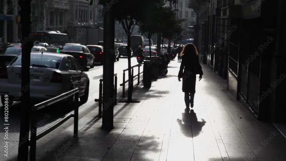 Woman walk by street with traffic in Madrid Woman walk by street with traffic in Madrid