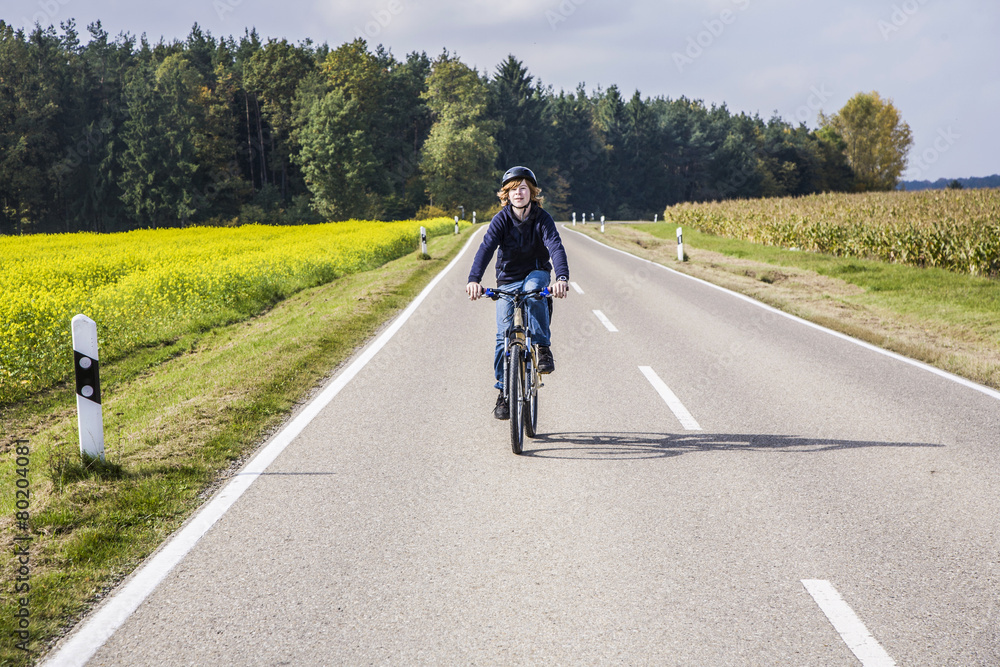 Fototapeta premium young boy with bike in rural area