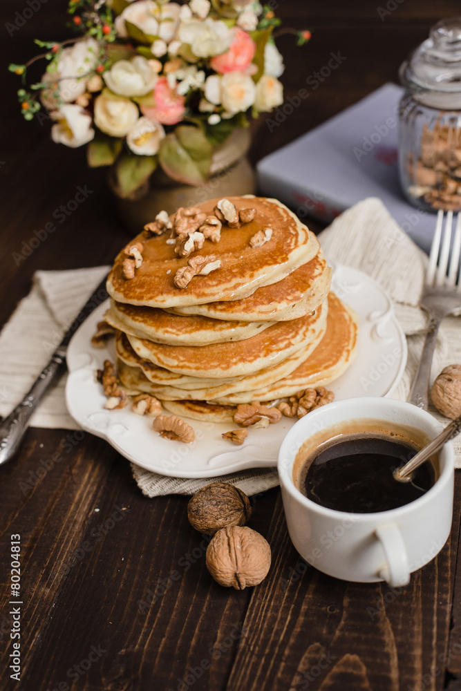 Stack of pancakes with honey,banana and walnuts Stack of pancakes with honey,banana and walnuts