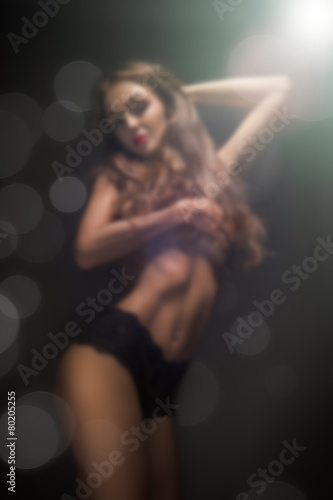 Photography topless girl in dark blurred background
