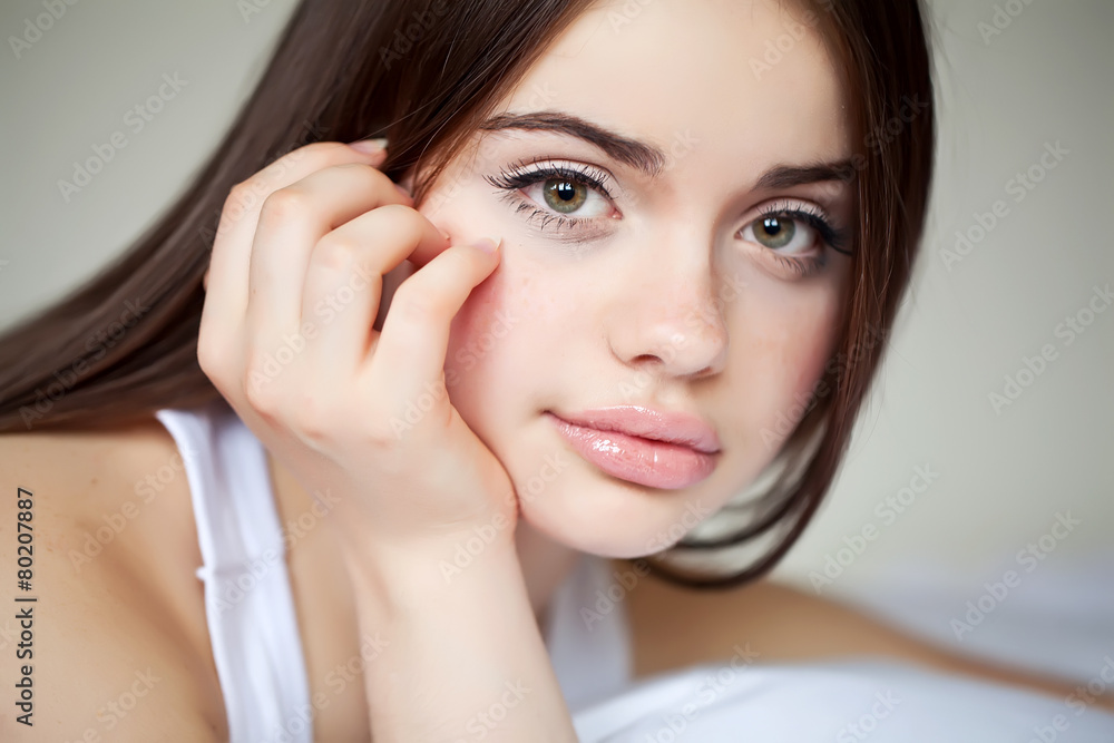 Fototapeta premium beautiful woman resting on the bed in white bedroom 