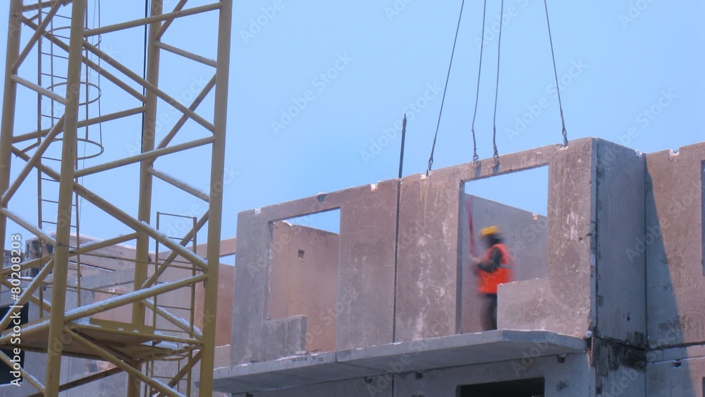 Workers securing block panel on building. Timelapse Workers securing block panel on building. Timelapse
