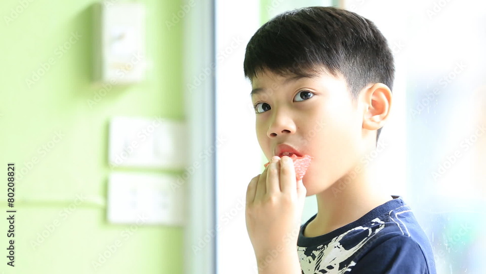 Little asian cute boy eats ripe watermelon Little asian cute boy eats ripe watermelon
