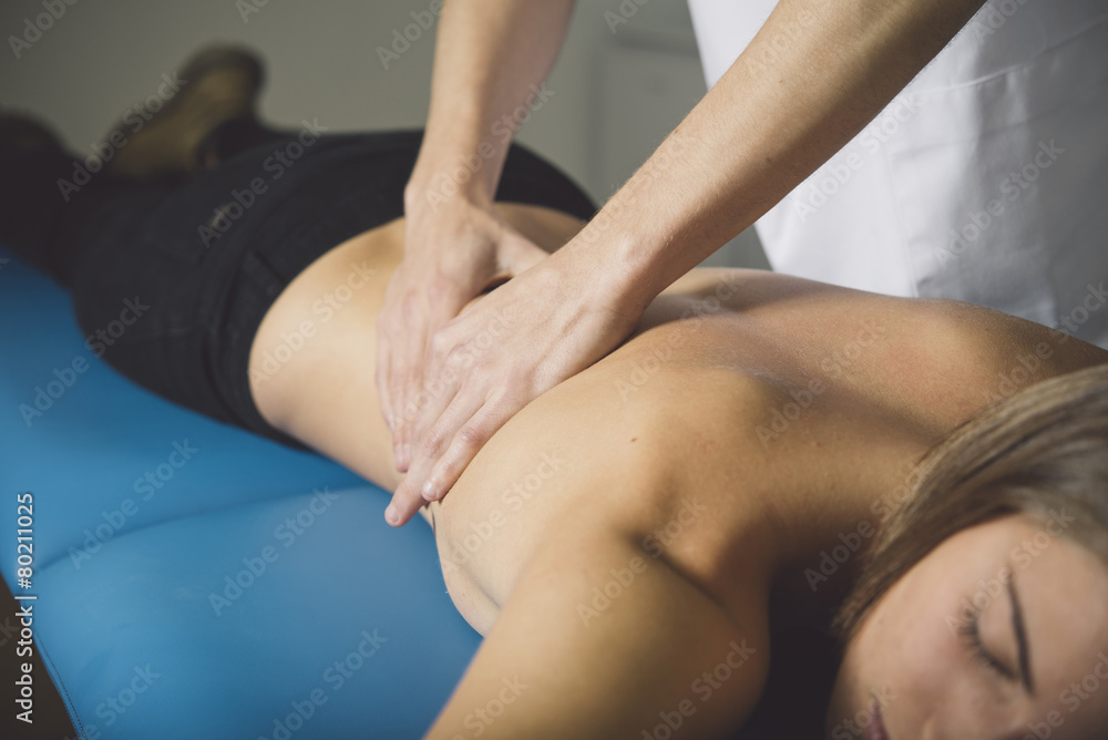 Fototapeta premium Beautiful young woman relaxing with hand massage at beauty spa