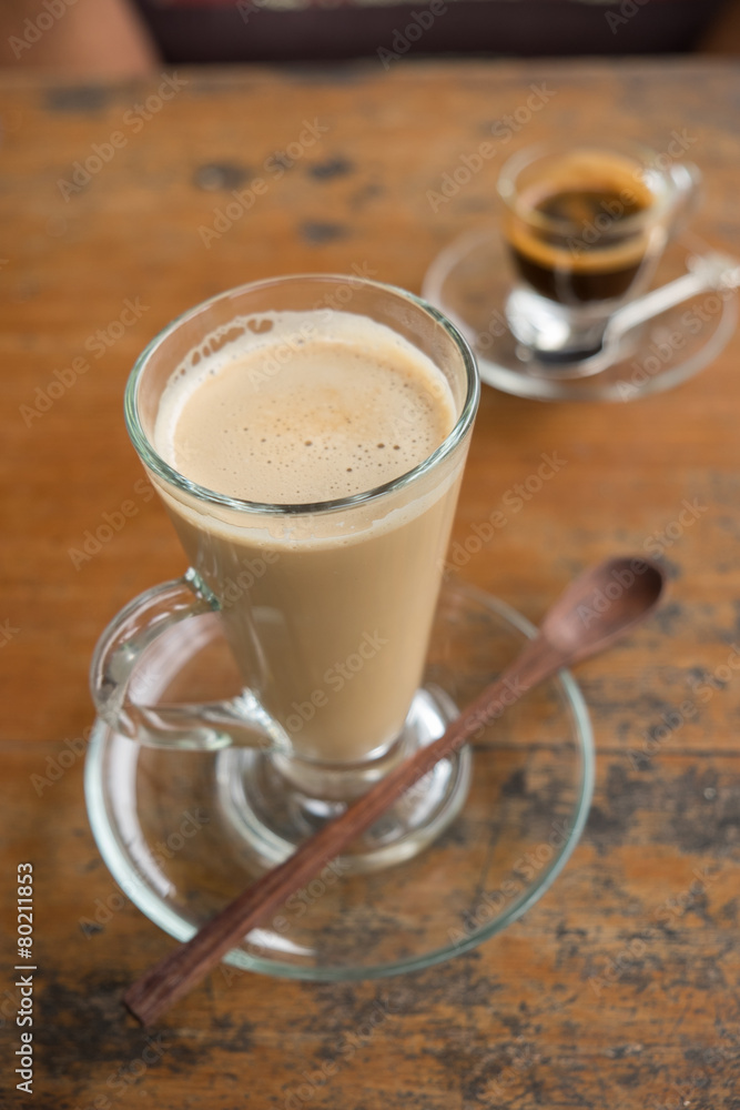coffee latte in tall glass with wooden spoon coffee latte in tall glass with wooden spoon