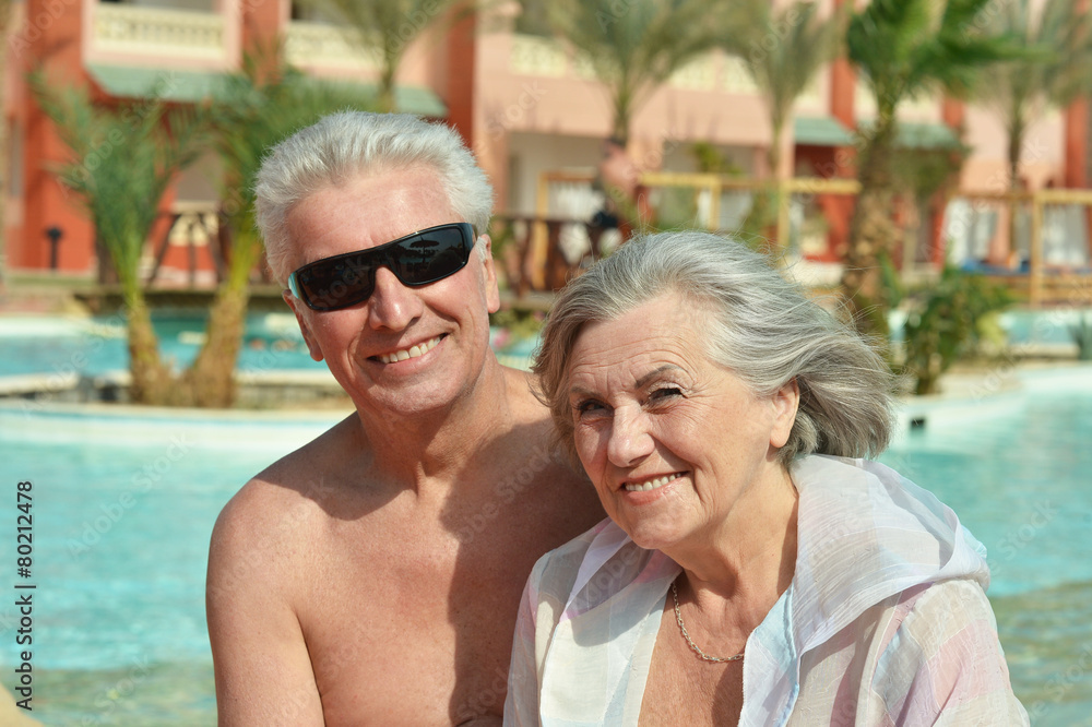 Elderly couple over pool