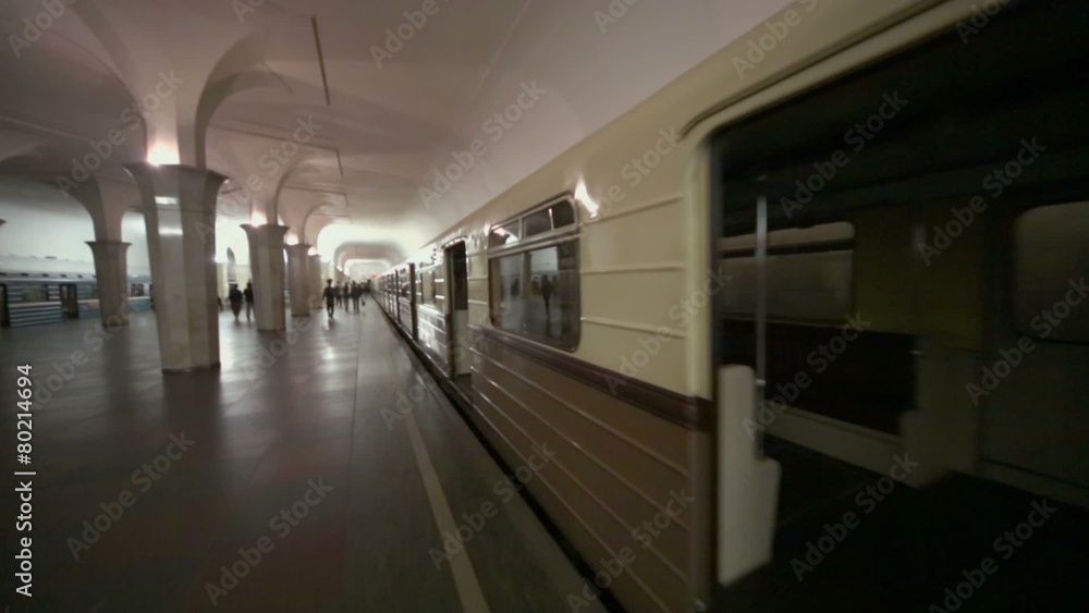 Policemen and people walk by platform near retro suburban train Policemen and people walk by platform near retro suburban train