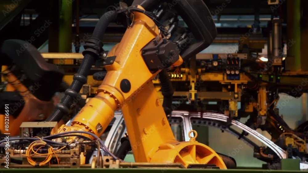Robotics work in car assembly conveyor at factory, closeup Robotics work in car assembly conveyor at factory, closeup