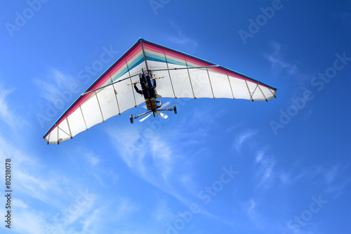 Fotografie The motorized hang glider in the blue sky