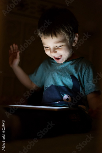 kid with tablet in the dark