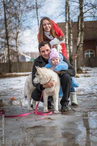 Young lovely family walk in bright sunny winter day