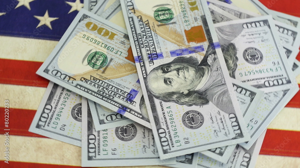 Pile of hundred dollar bills on American flag in 4K UHD video. Pile of hundred dollar bills on American flag in 4K UHD video.