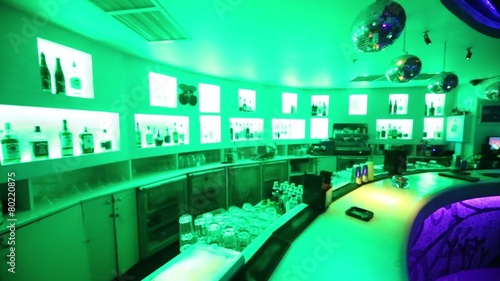 Bar counter in night club illuminated with flashing lights. photo