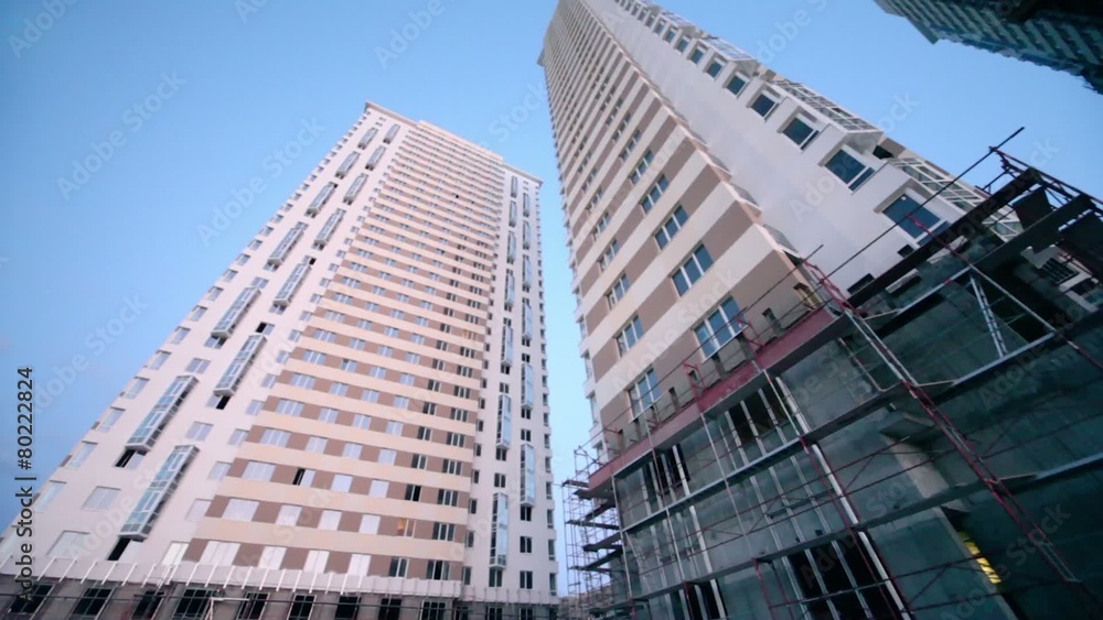 Construction site of tall dwelling houses at evening Construction site of tall dwelling houses at evening