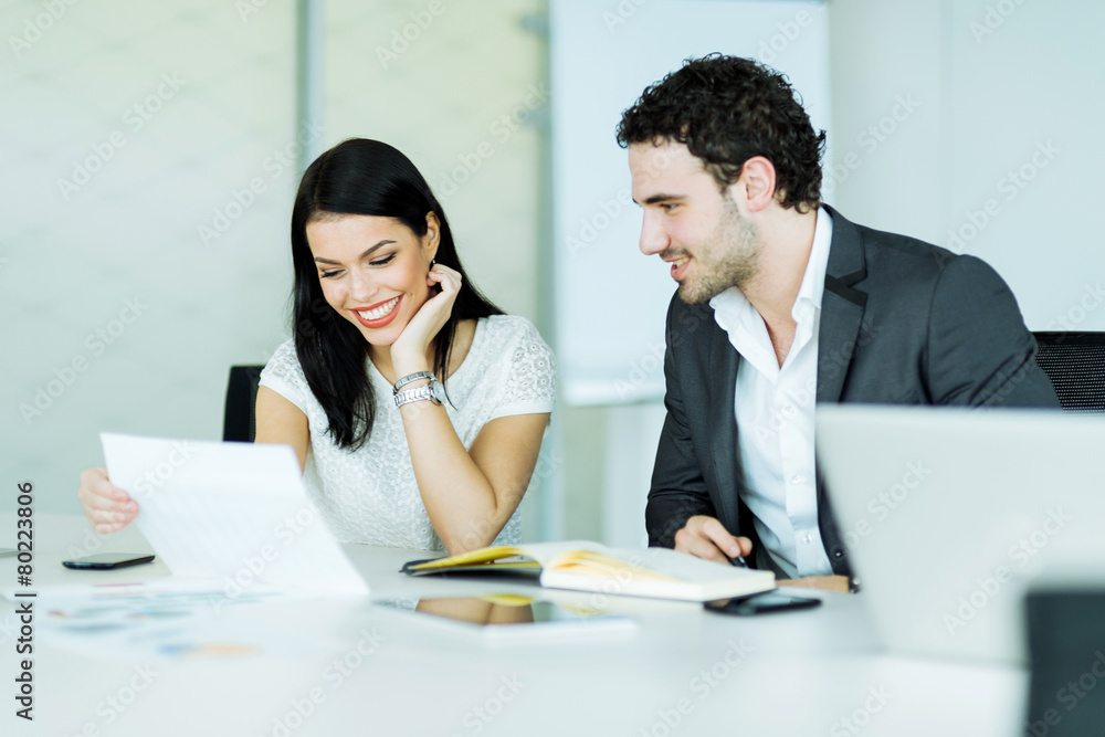 Happy atmosphere between colleagues in an office during work Happy atmosphere between colleagues in an office during work