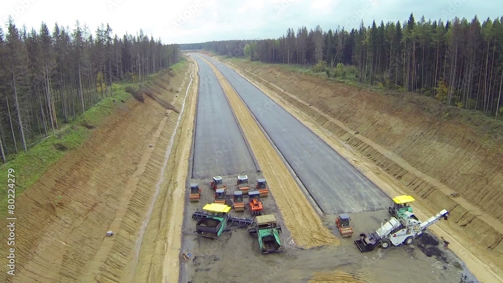 Special equipment for asphalting road in a rainy day, above view Special equipment for asphalting road in a rainy day, above view