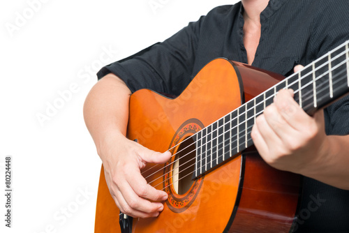 Female hands playing an acoustic guitar