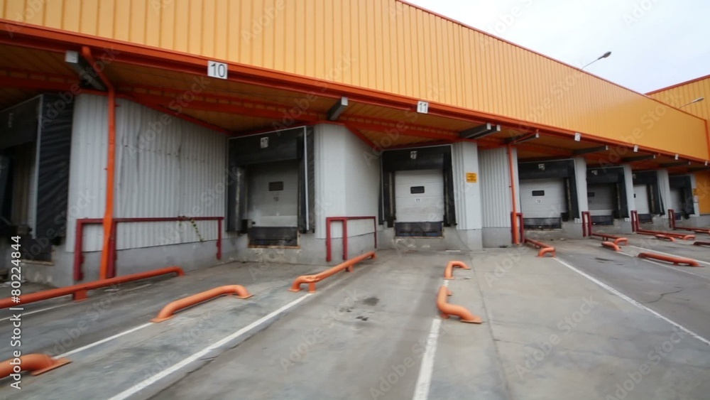 Several gates for trucks to load goods on a large warehouse Several gates for trucks to load goods on a large warehouse