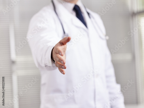 Doctor with open hand ready for handshake