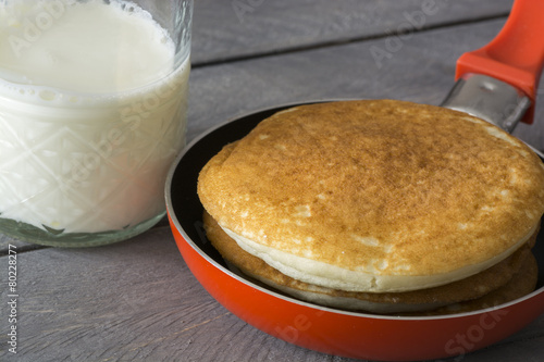 Pancakes and glass of milk.