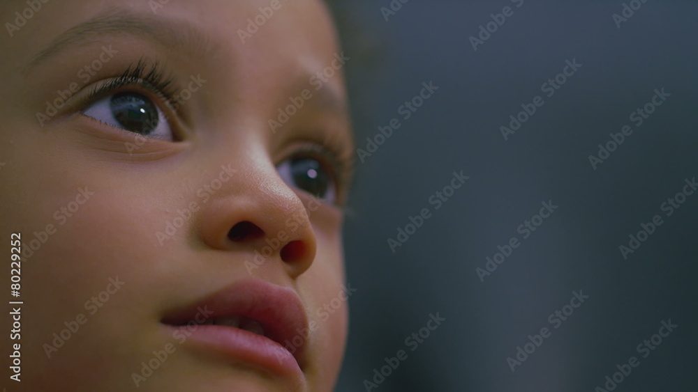 Little girl focused on a video game as she plays